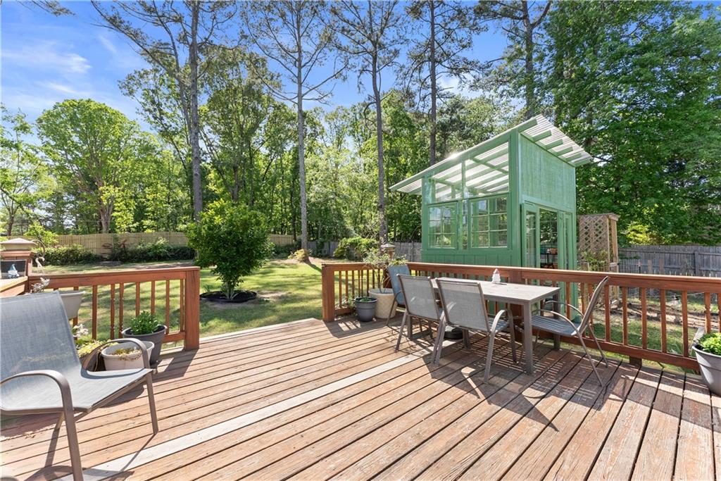 709 Muirfield Drive Winder, GA 30680 - Photo 48 of 65 a view of a chairs and table on the wooden deck