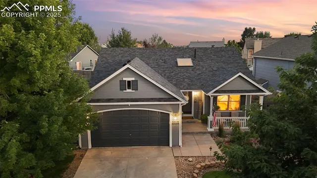 an aerial view of a house with a yard