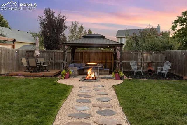 a view of a backyard with sitting area and slide