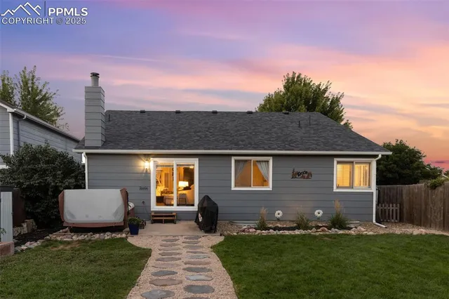 a front view of a house with a garden and yard