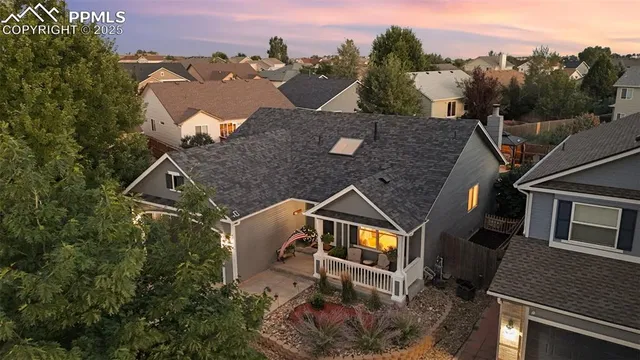an aerial view of a house with a yard