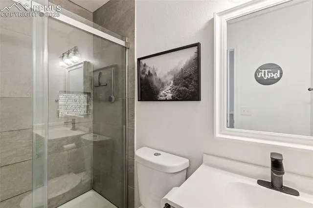 a bathroom with a toilet a sink and shower