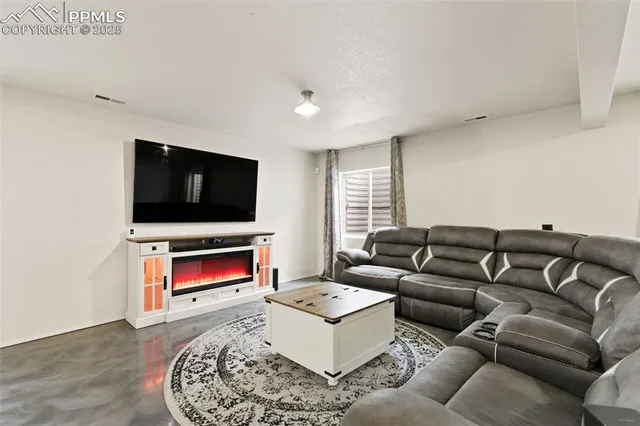 a living room with furniture and a flat screen tv