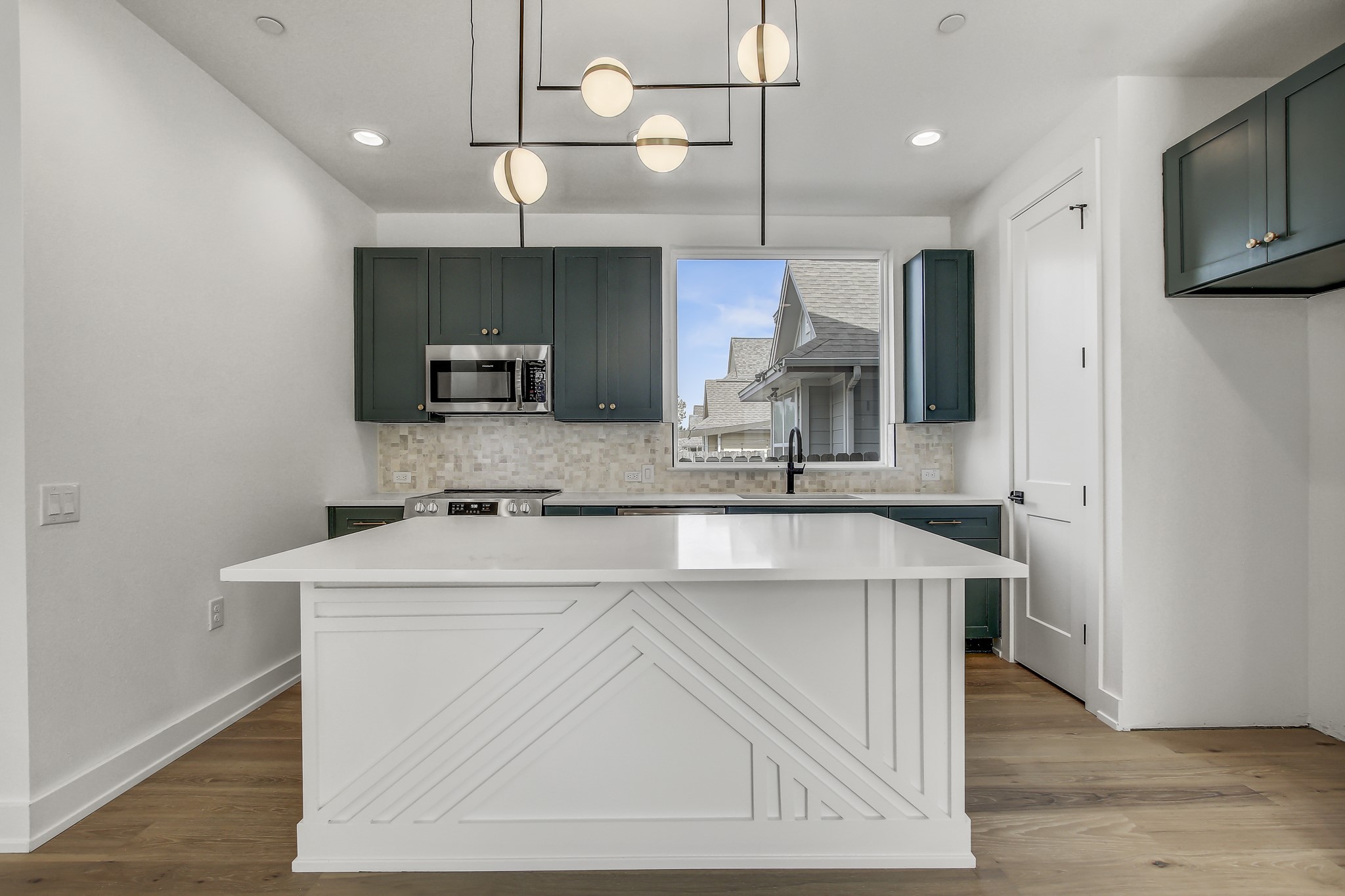 4127 East 12th Street, Unit 1 Austin, TX 78721 - Photo 1 of 30 a kitchen with kitchen island a sink stainless steel appliances and cabinets
