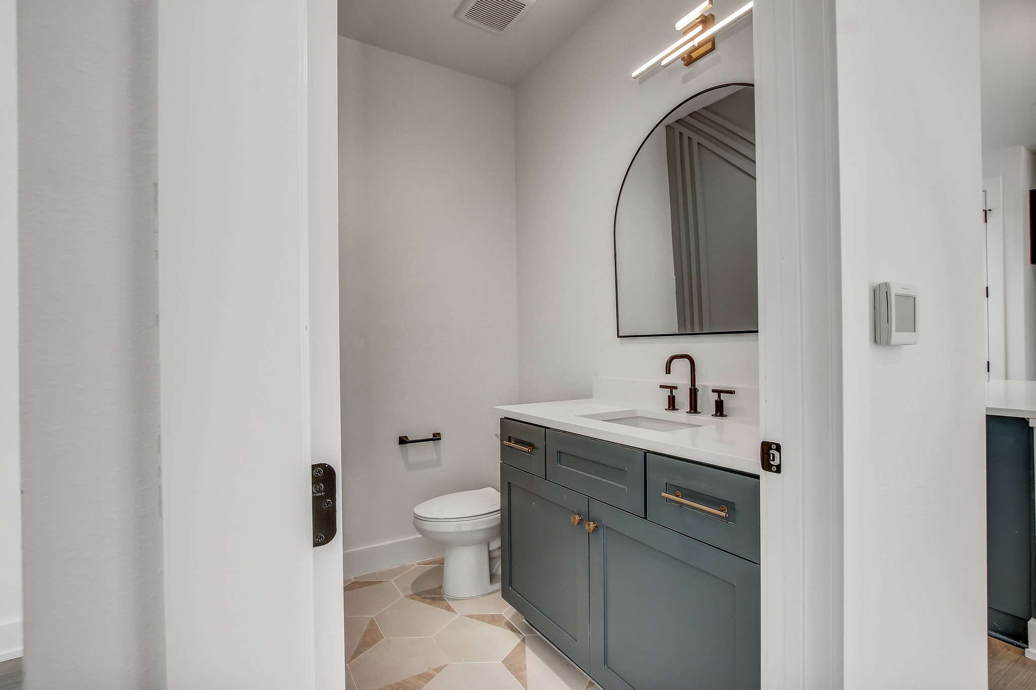 4127 East 12th Street, Unit 1 Austin, TX 78721 - Photo 11 of 30 a bathroom with a toilet sink and mirror