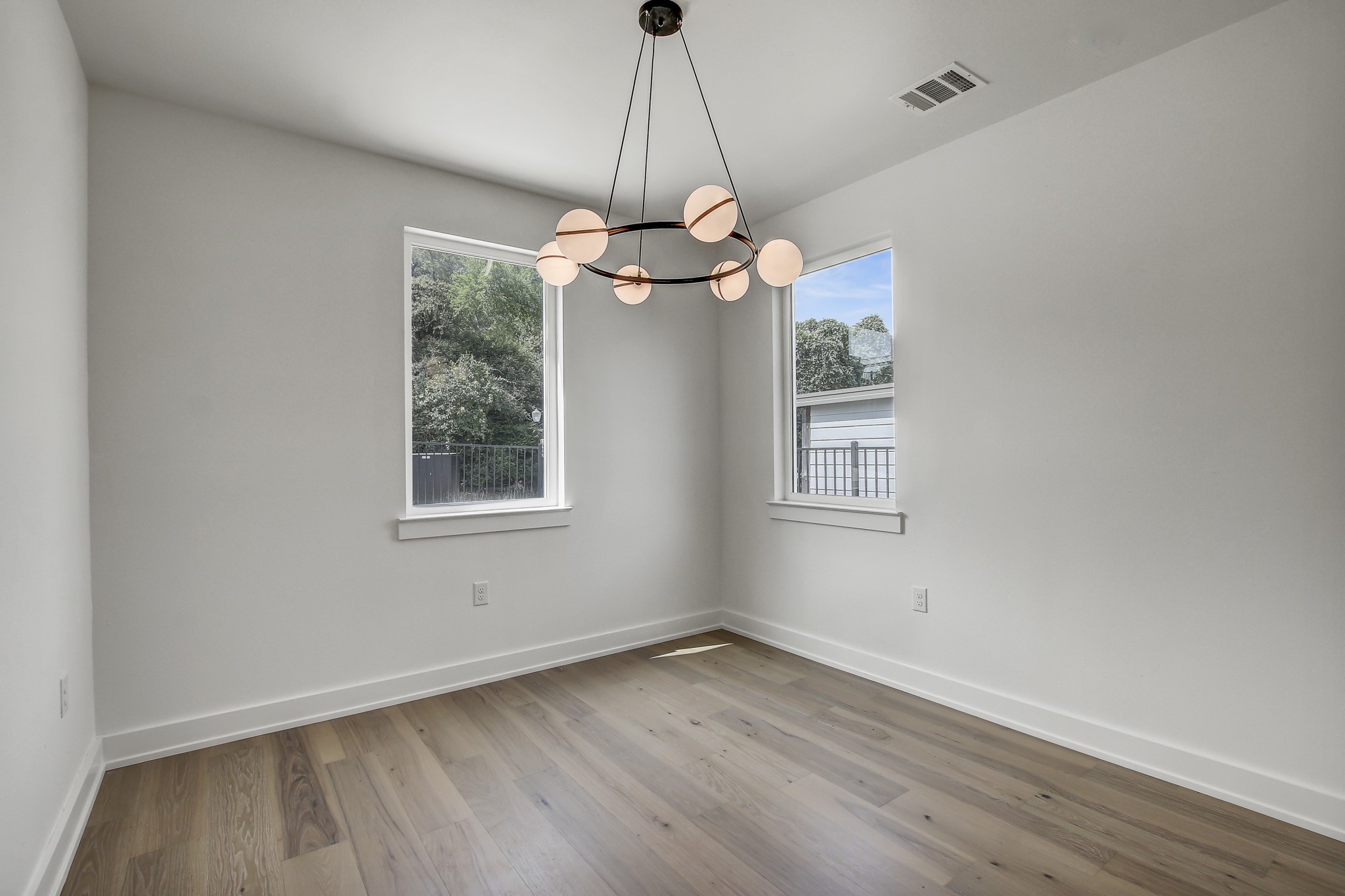 4127 East 12th Street, Unit 1 Austin, TX 78721 - Photo 12 of 30 a dining room with wooden floor a chandelier and window