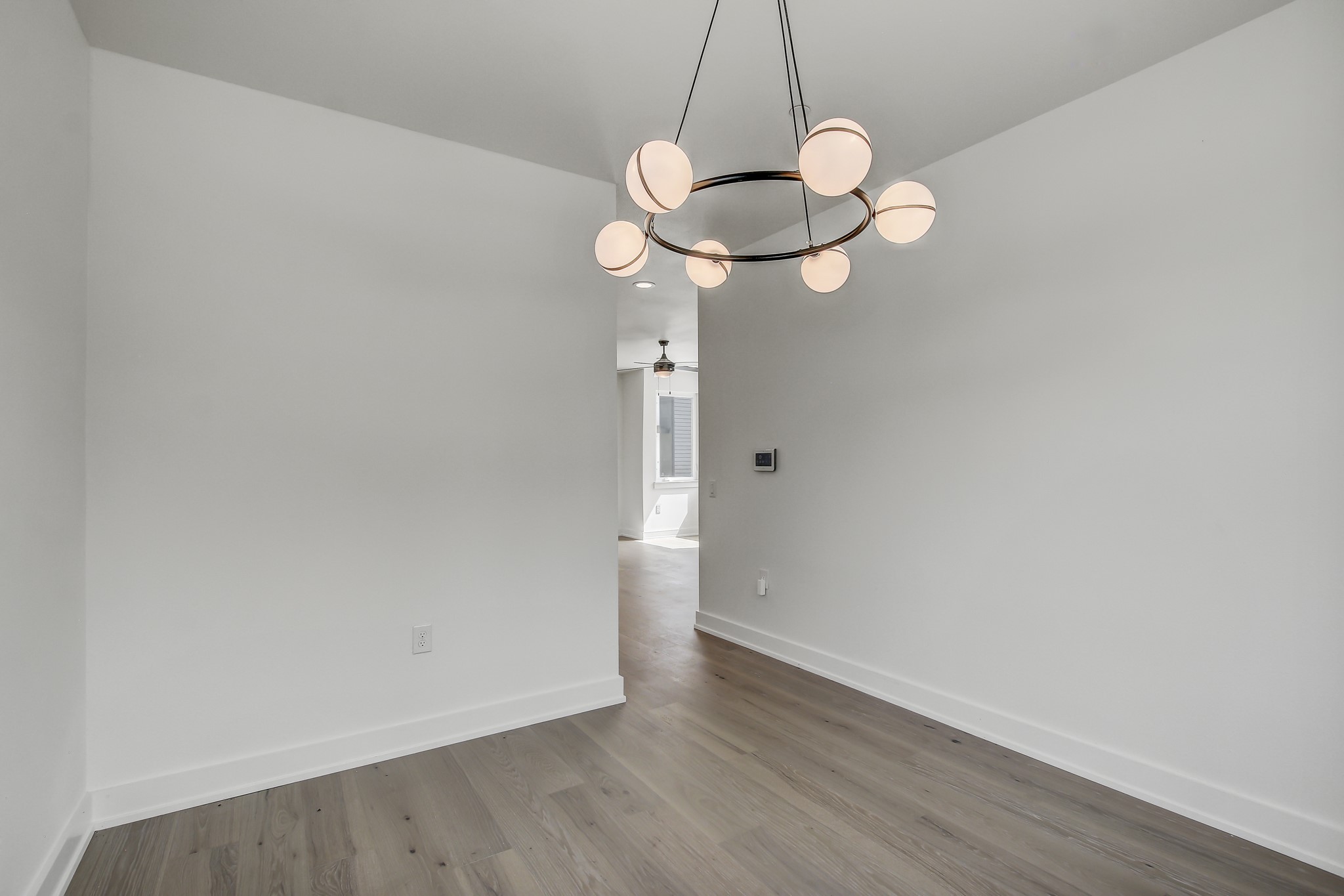 4127 East 12th Street, Unit 1 Austin, TX 78721 - Photo 13 of 30 a view of a room with wooden floor and fan