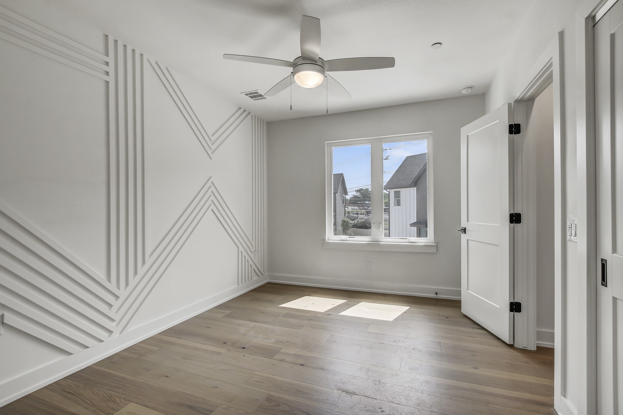 4127 East 12th Street, Unit 1 Austin, TX 78721 - Photo 14 of 30 wooden floor in an empty room with a window