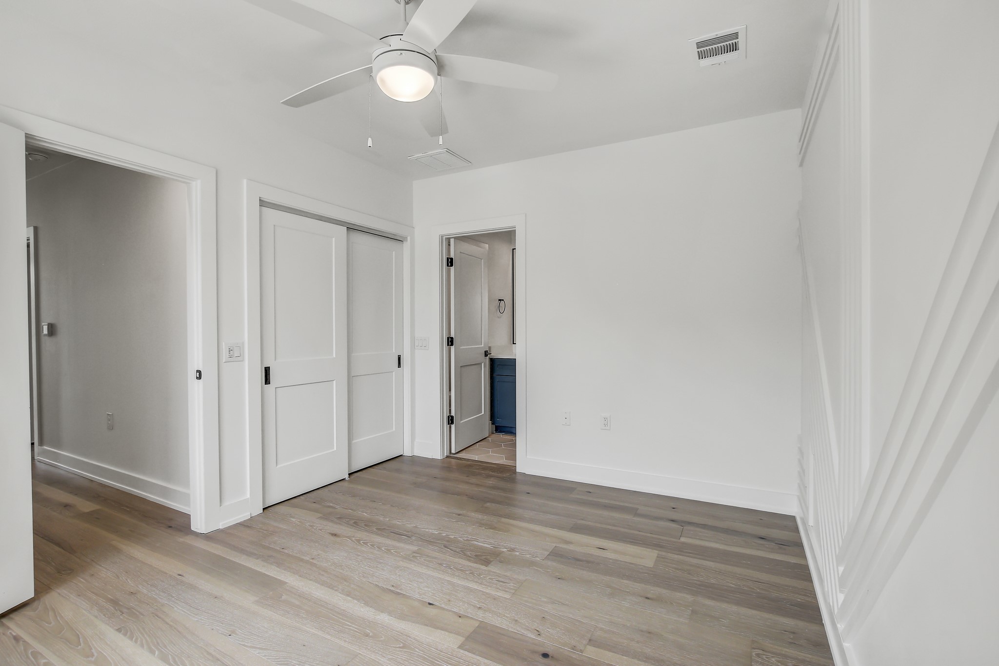 4127 East 12th Street, Unit 1 Austin, TX 78721 - Photo 15 of 30 an empty room with wooden floor and ceiling fan