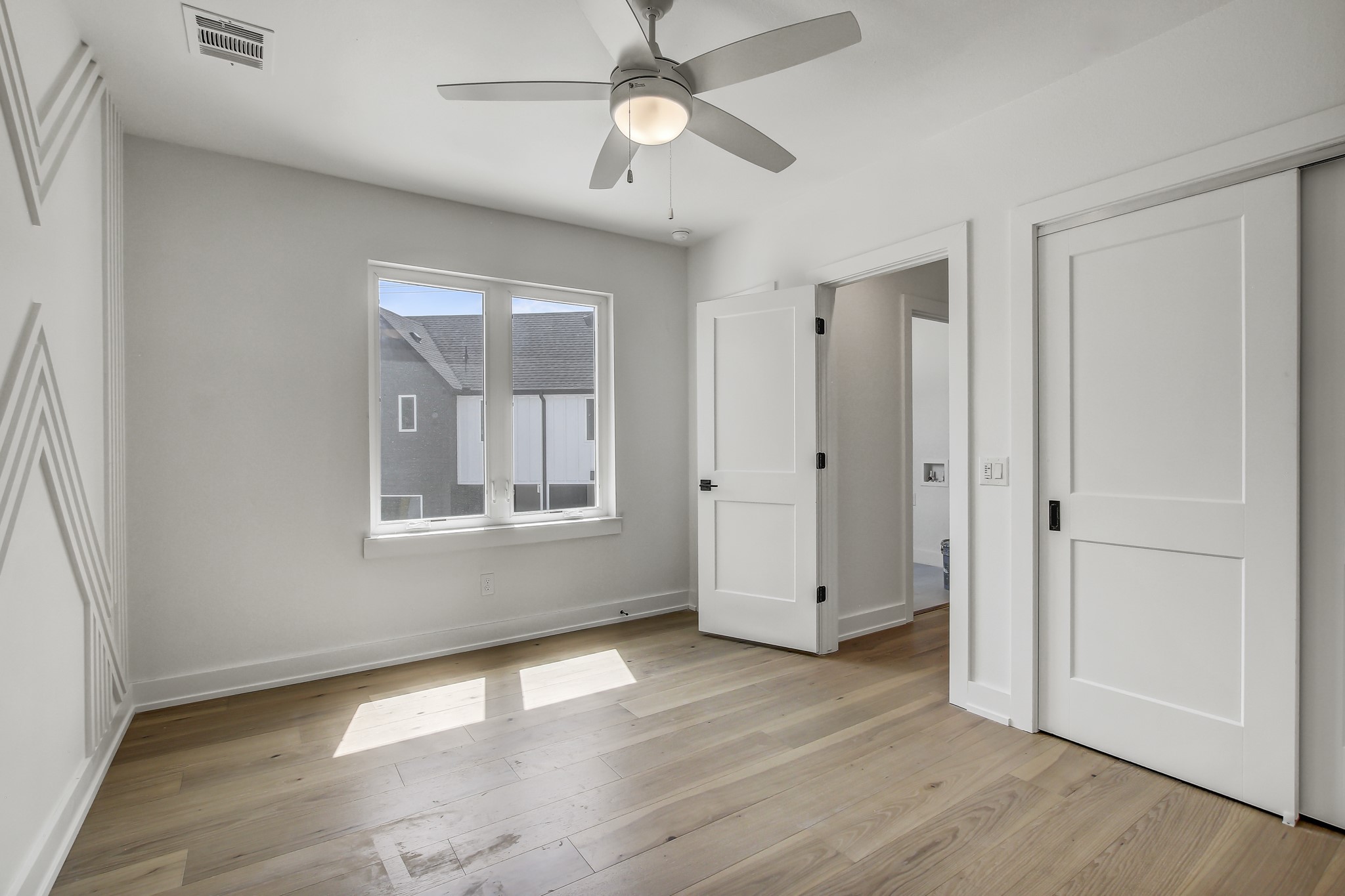 4127 East 12th Street, Unit 1 Austin, TX 78721 - Photo 16 of 30 wooden floor in an empty room with a window