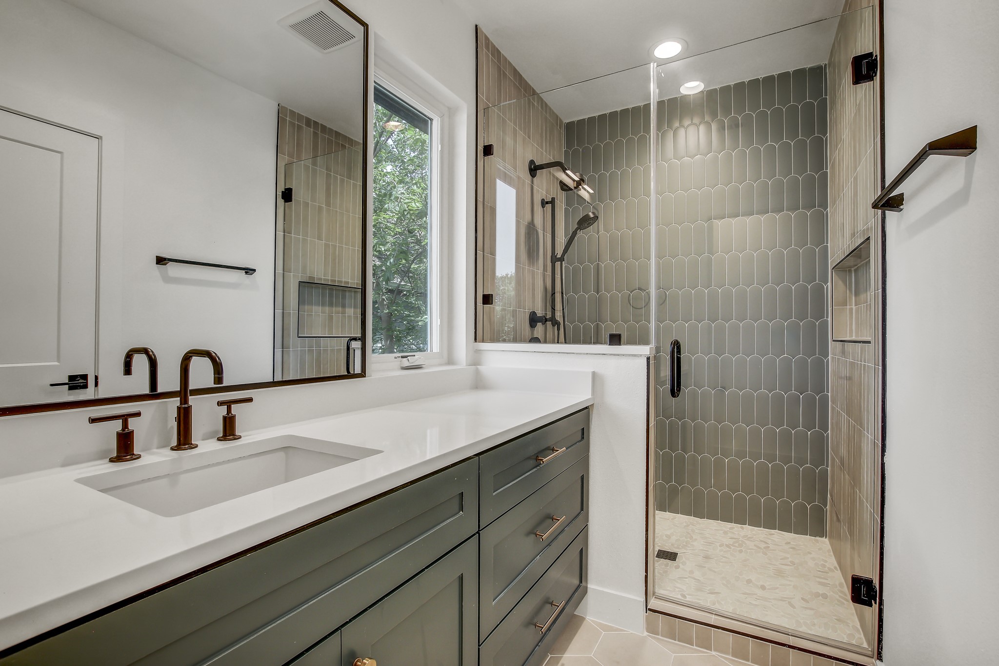 4127 East 12th Street, Unit 1 Austin, TX 78721 - Photo 17 of 30 a bathroom with a shower sink and mirror