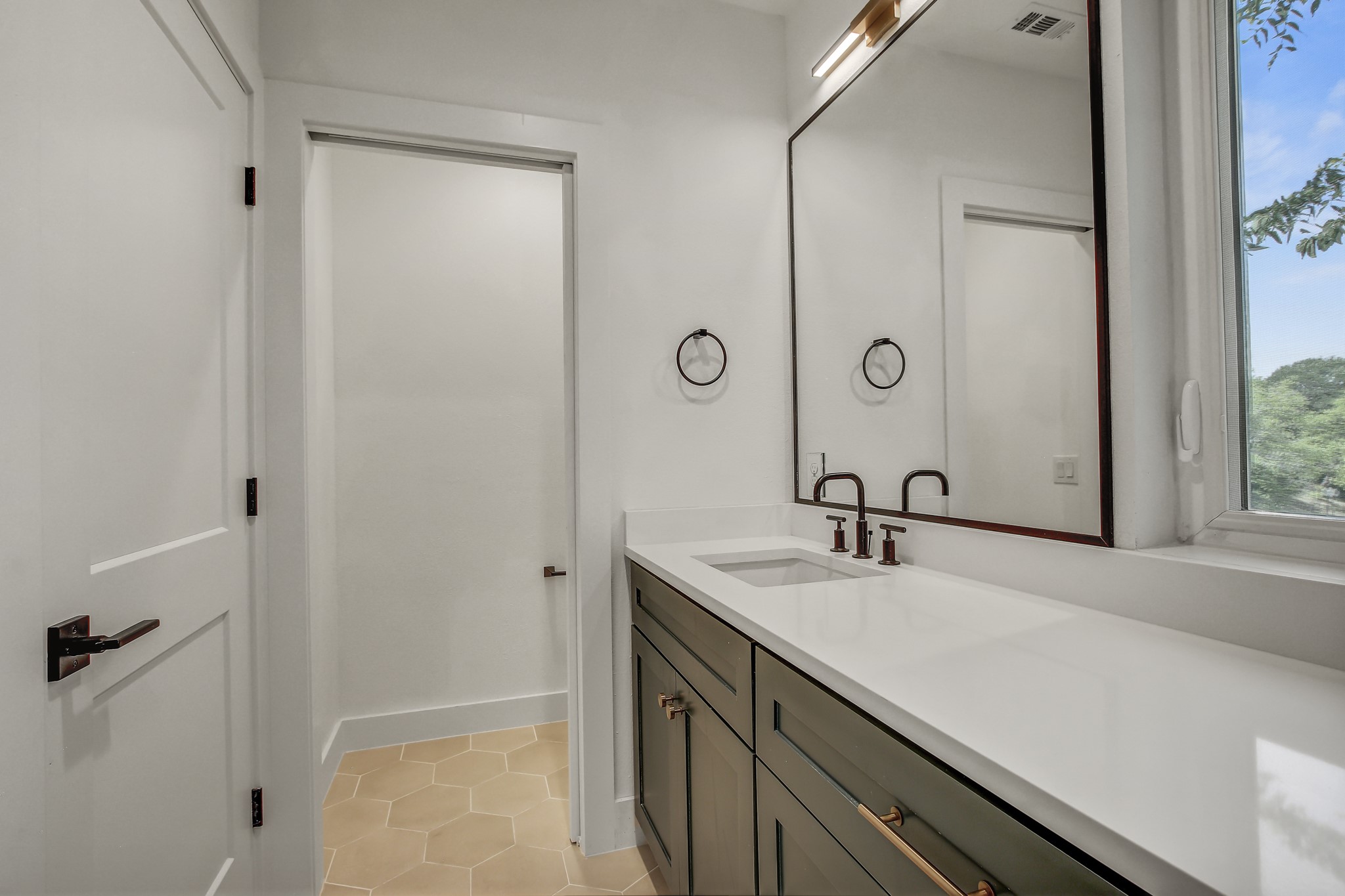 4127 East 12th Street, Unit 1 Austin, TX 78721 - Photo 18 of 30 a bathroom with a sink and a mirror