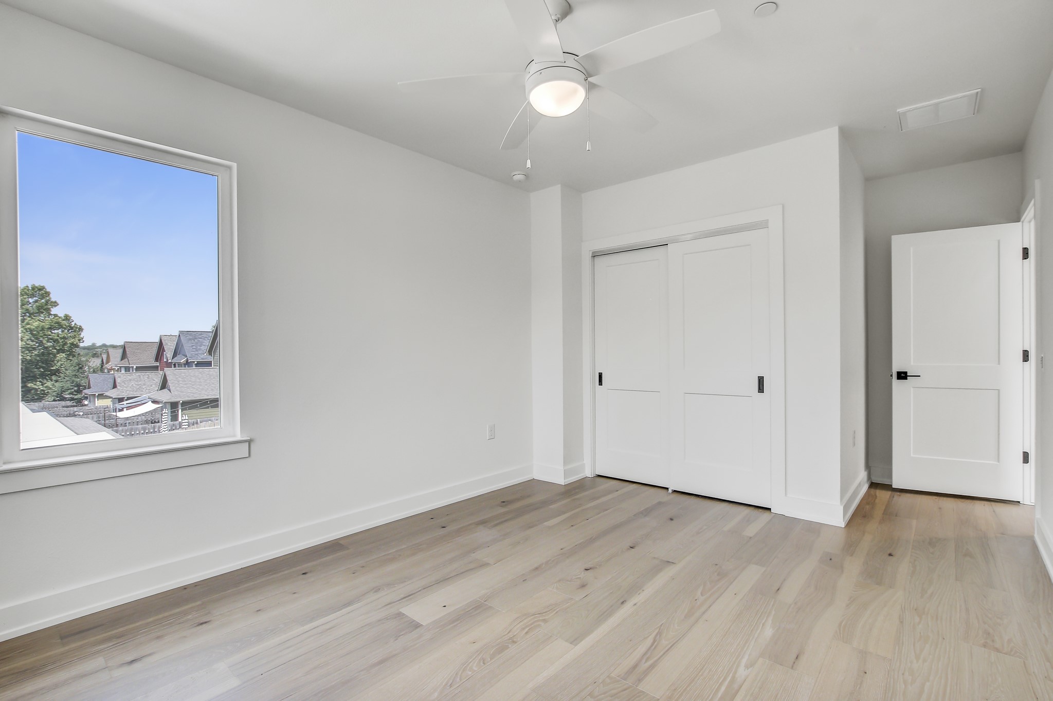 4127 East 12th Street, Unit 1 Austin, TX 78721 - Photo 20 of 30 an empty room with wooden floor and windows