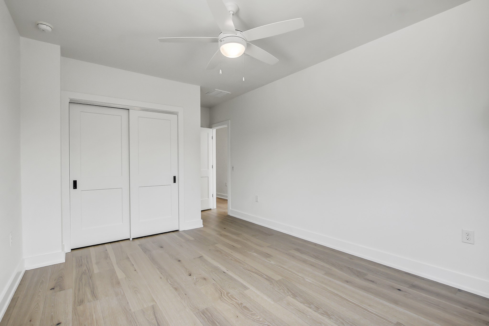4127 East 12th Street, Unit 1 Austin, TX 78721 - Photo 21 of 30 an empty room with wooden floor and windows