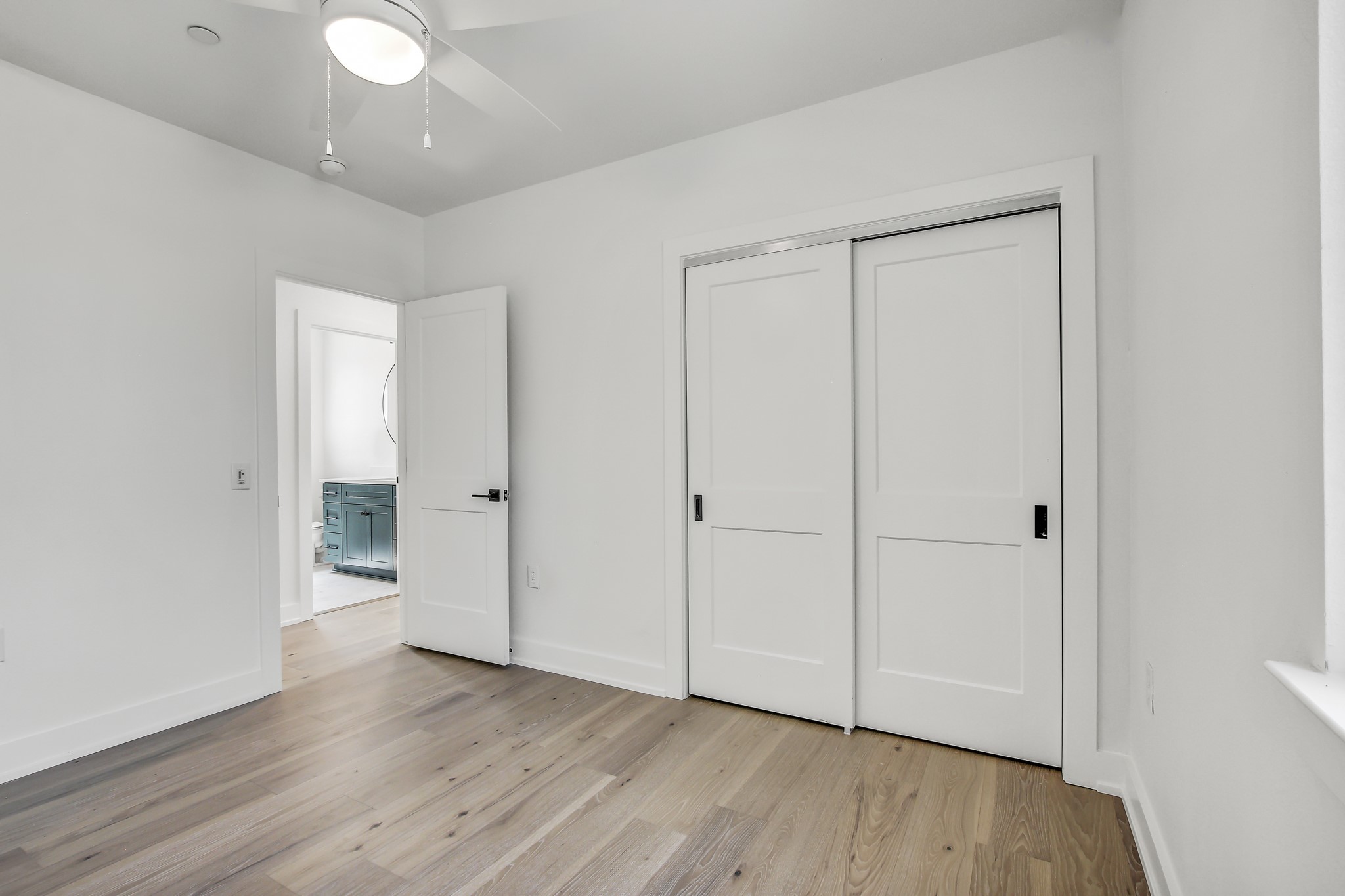 4127 East 12th Street, Unit 1 Austin, TX 78721 - Photo 25 of 30 an empty room with wooden floor and white walls