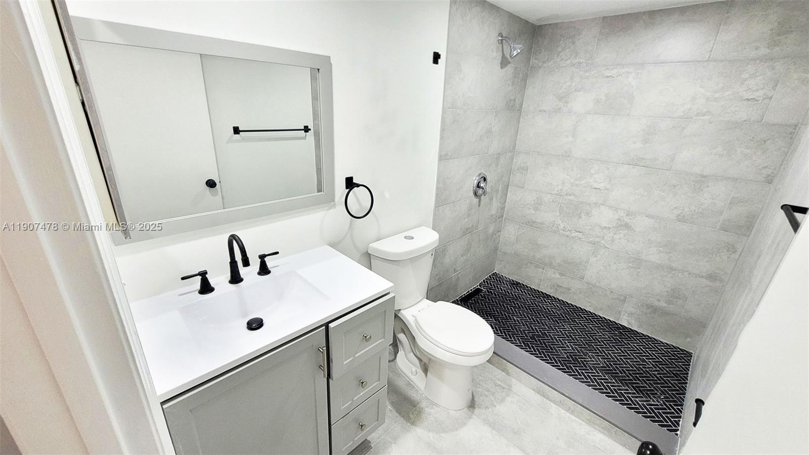 12124 St Andrews Place, Unit 203 Miramar, FL 33025 - Photo 11 of 29 a bathroom with a sink toilet and shower