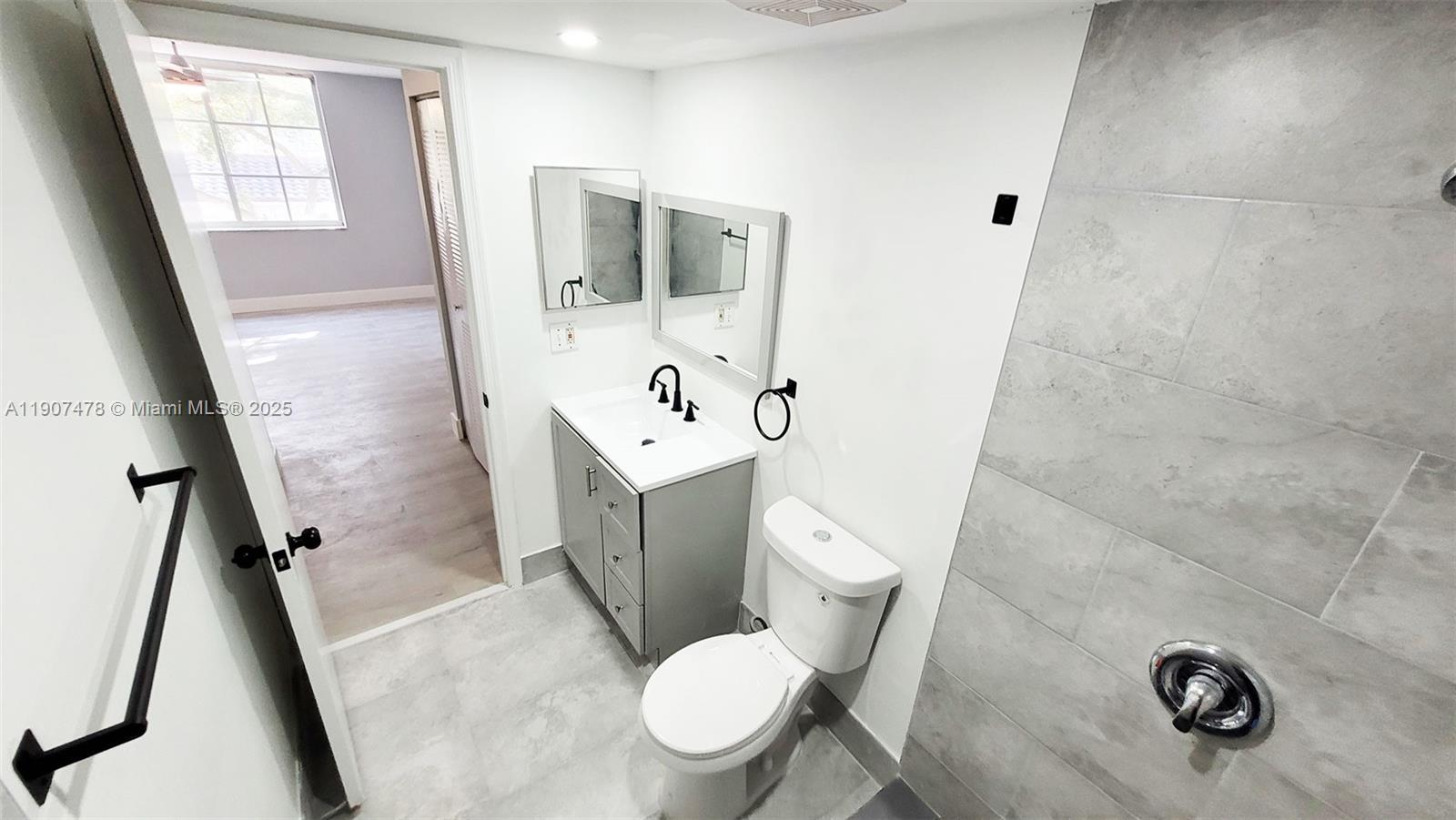 12124 St Andrews Place, Unit 203 Miramar, FL 33025 - Photo 12 of 29 a white toilet sitting next to a bathroom sink