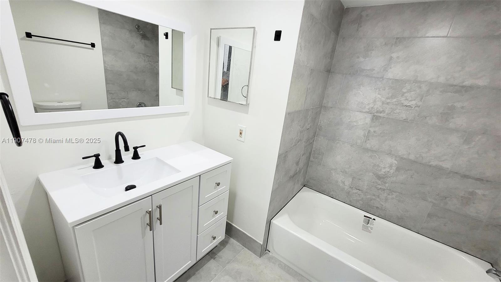 12124 St Andrews Place, Unit 203 Miramar, FL 33025 - Photo 14 of 29 a bathroom with a sink a toilet and shower