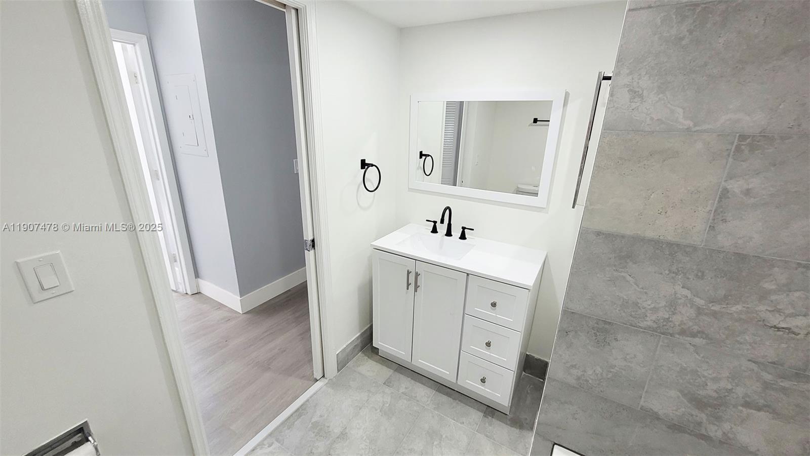12124 St Andrews Place, Unit 203 Miramar, FL 33025 - Photo 15 of 29 a spacious bathroom with a double vanity sink a mirror and a bathtub