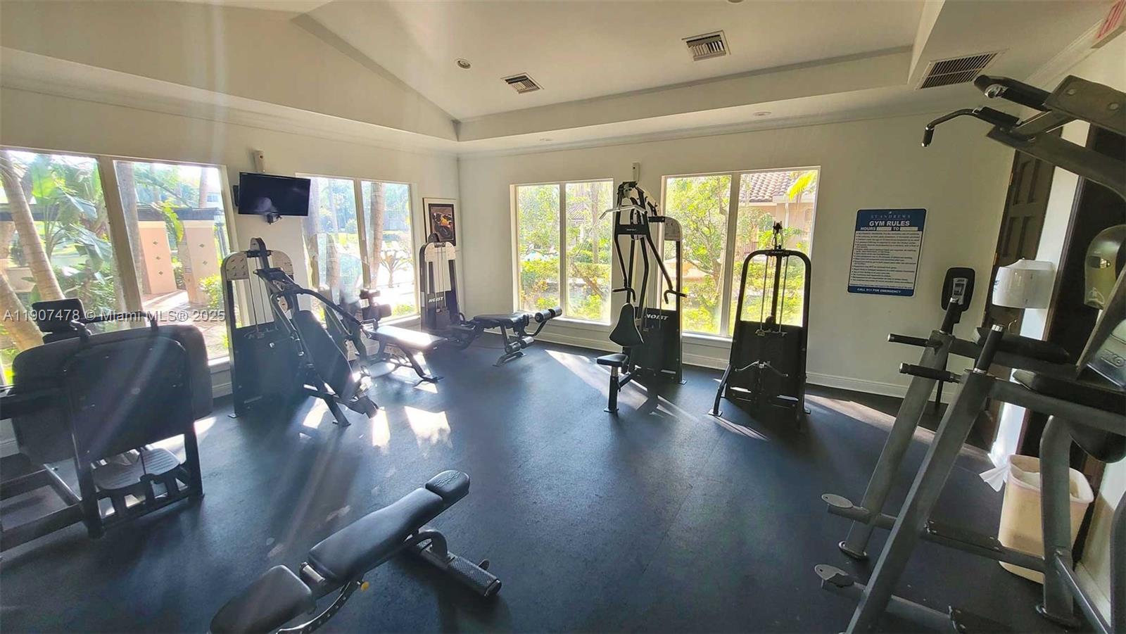 12124 St Andrews Place, Unit 203 Miramar, FL 33025 - Photo 17 of 29 a living room with furniture floor to ceiling window and a flat screen tv