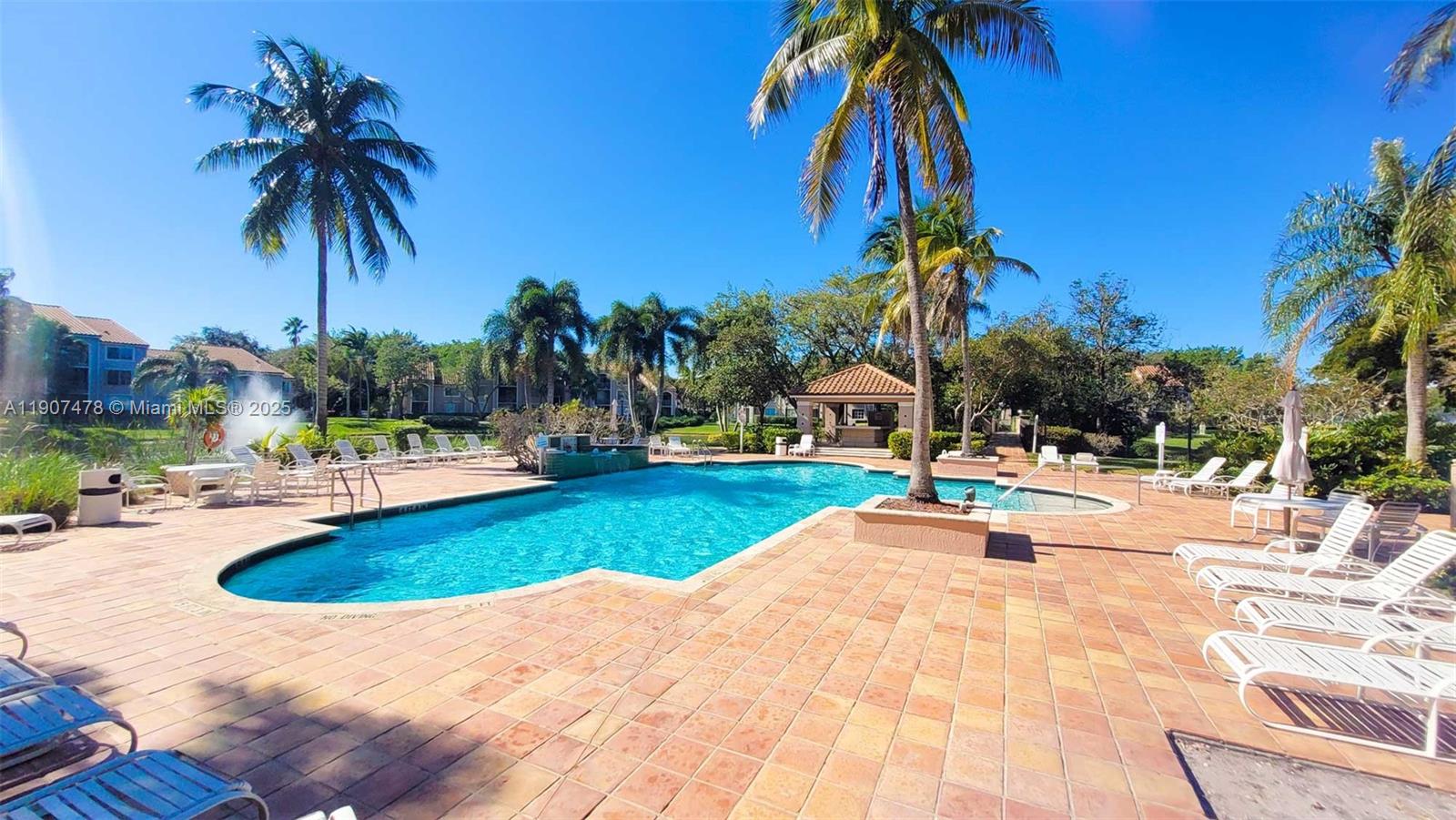 12124 St Andrews Place, Unit 203 Miramar, FL 33025 - Photo 18 of 29 a swimming pool with outdoor seating and yard