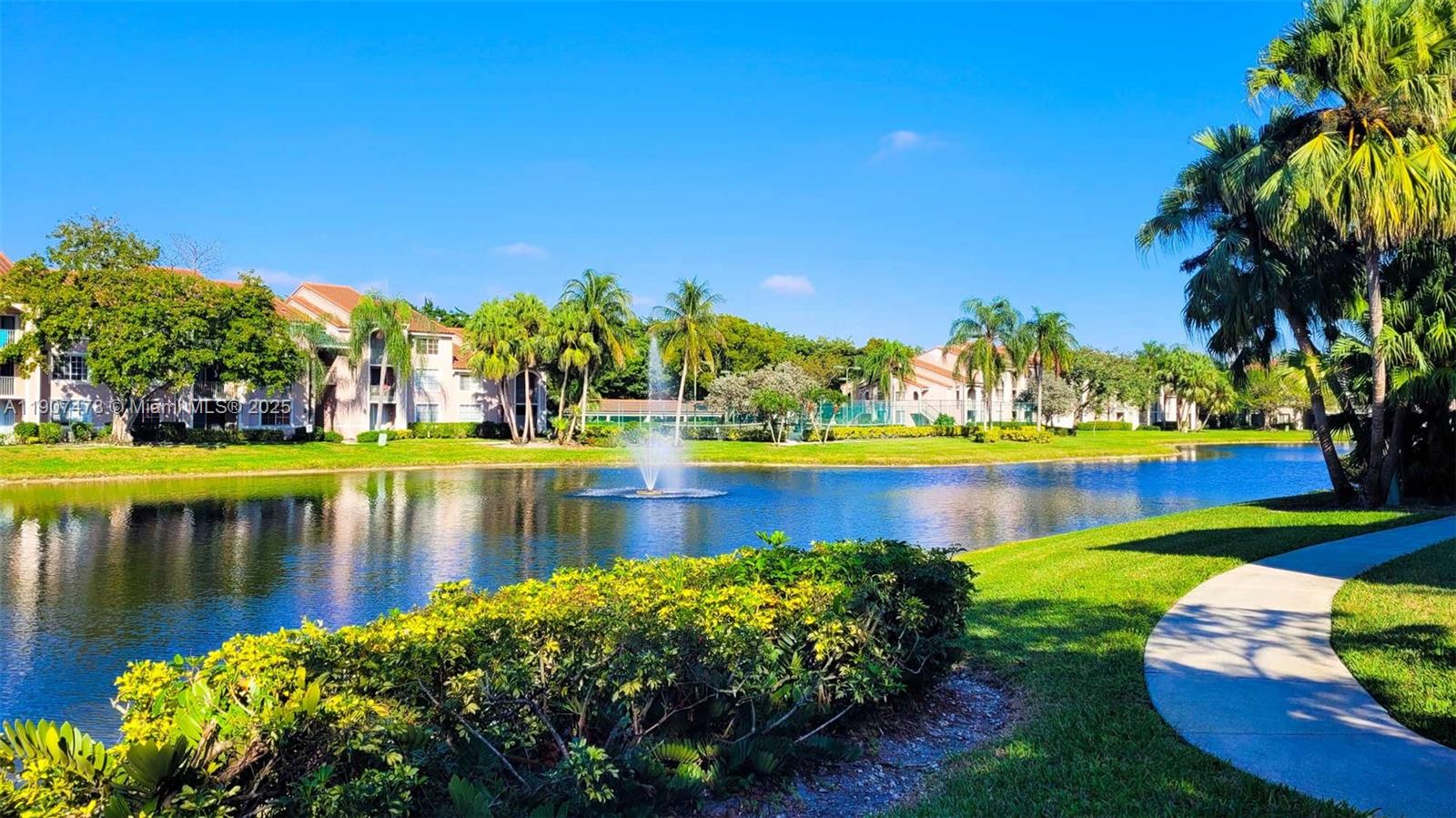 12124 St Andrews Place, Unit 203 Miramar, FL 33025 - Photo 21 of 29 a view of a lake with a house in the background