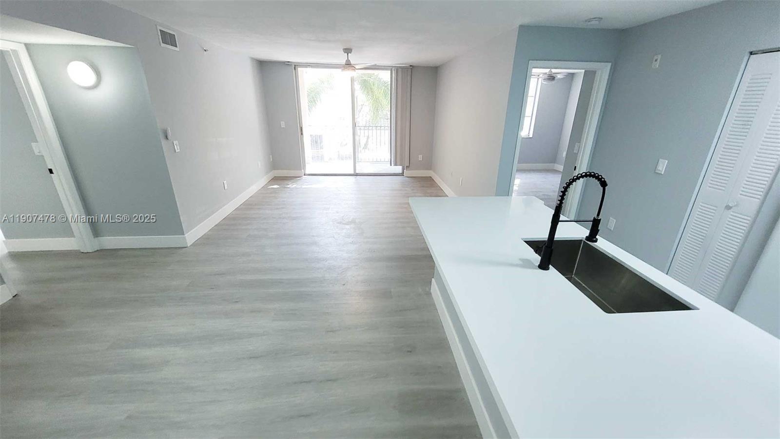 12124 St Andrews Place, Unit 203 Miramar, FL 33025 - Photo 3 of 29 a hallway with a large window in it