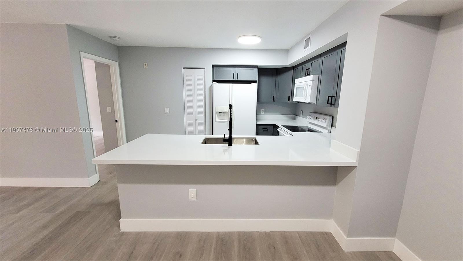 12124 St Andrews Place, Unit 203 Miramar, FL 33025 - Photo 6 of 29 a bathroom with a sink and a mirror