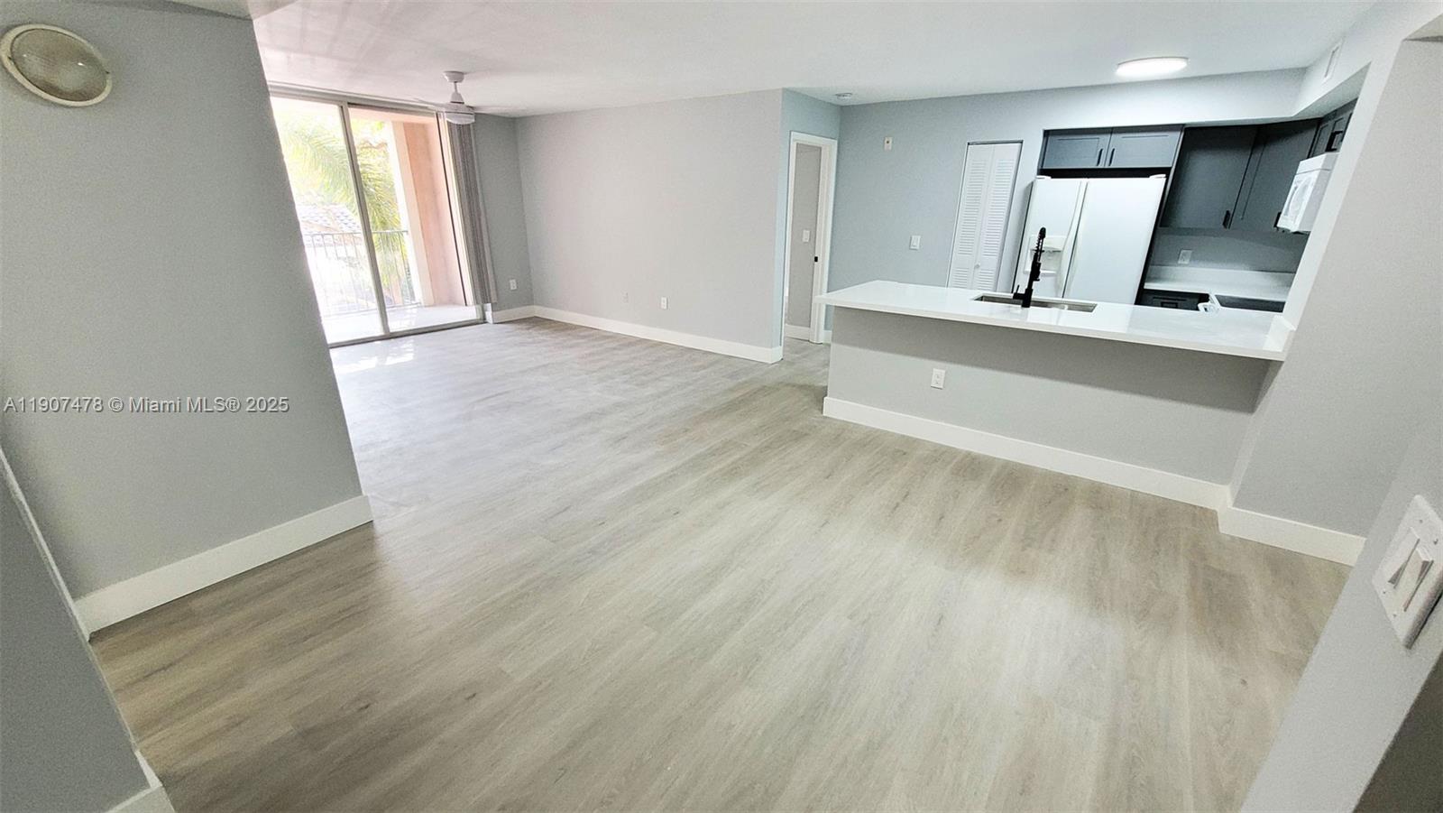 12124 St Andrews Place, Unit 203 Miramar, FL 33025 - Photo 7 of 29 wooden floor in an empty room with a window