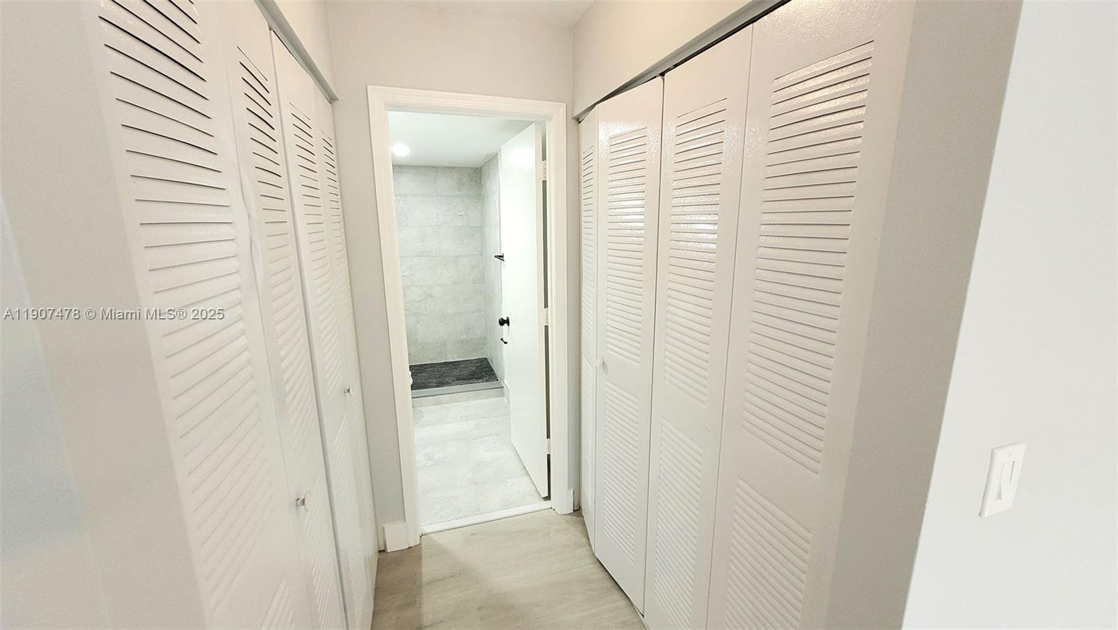 12124 St Andrews Place, Unit 203 Miramar, FL 33025 - Photo 8 of 29 a view of a bathroom from a hallway