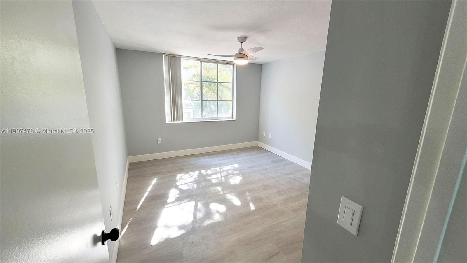 12124 St Andrews Place, Unit 203 Miramar, FL 33025 - Photo 10 of 29 a view of an empty room with a window