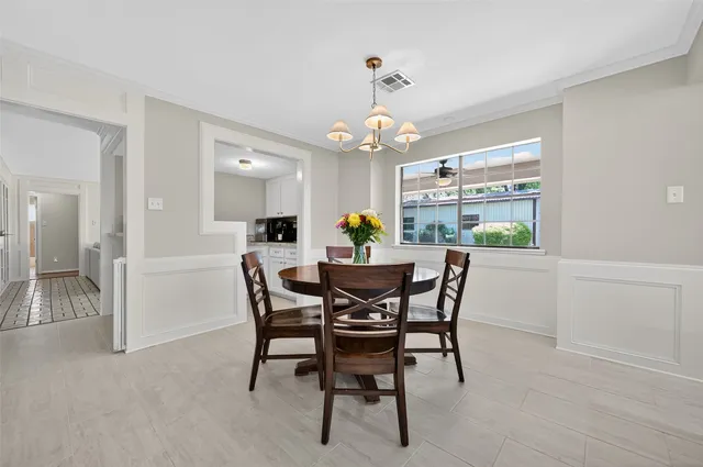 a view of a dining room with furniture and chandelier