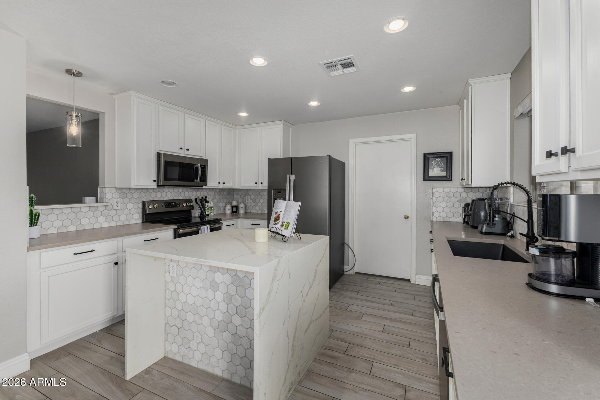 1022 East Pedro Road Phoenix, AZ 85042 - Photo 12 of 29 a kitchen with sink a refrigerator and a stove top oven