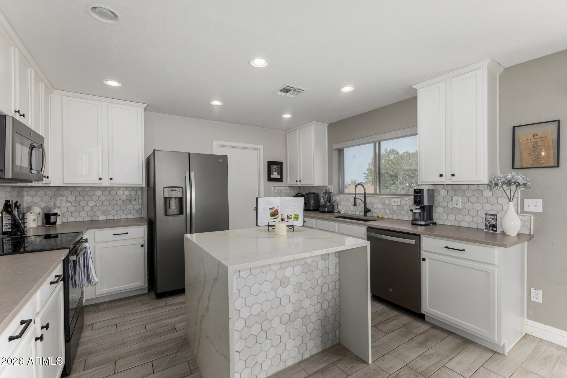 1022 East Pedro Road Phoenix, AZ 85042 - Photo 13 of 29 a kitchen with stainless steel appliances granite countertop a sink stove refrigerator and cabinets