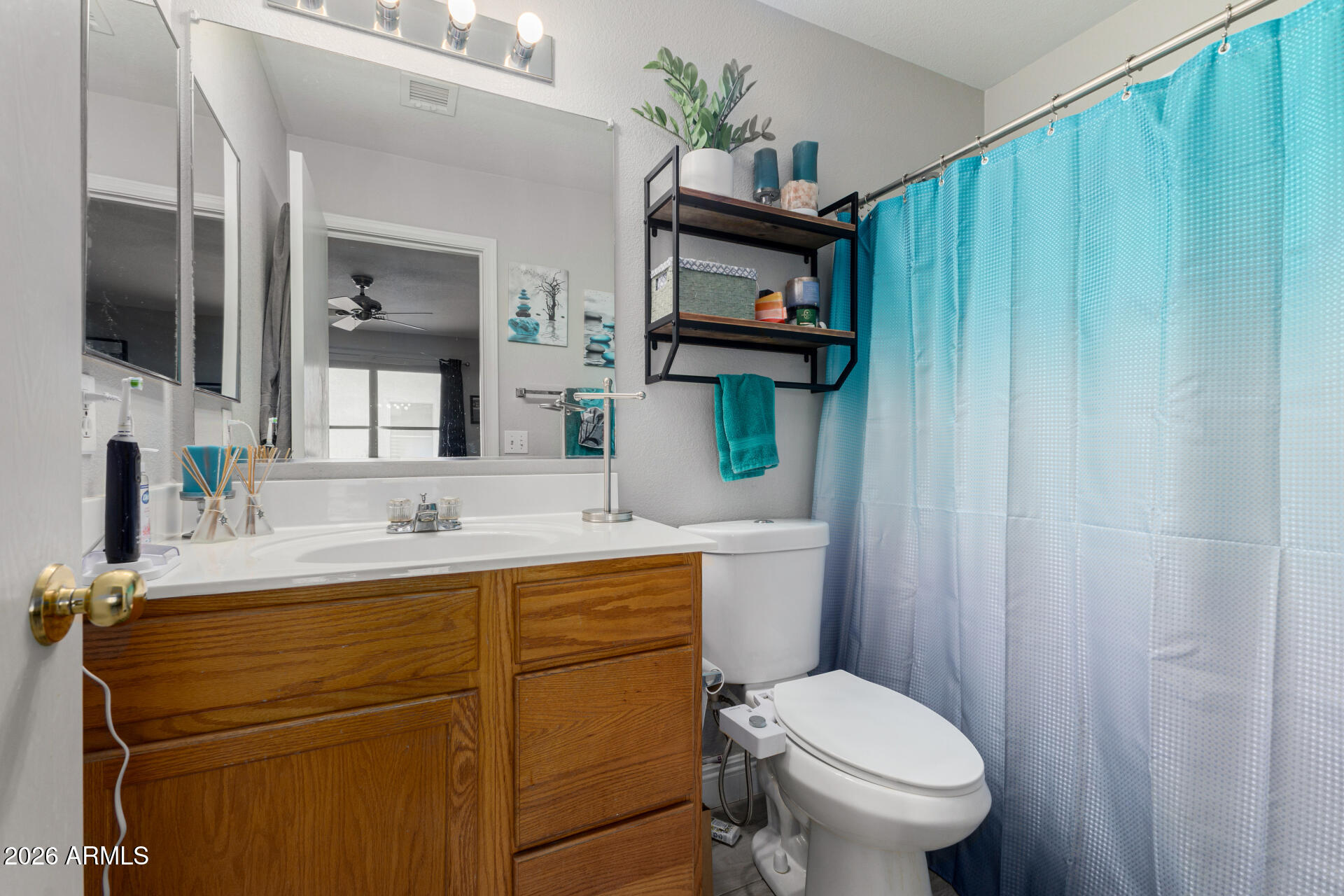 1022 East Pedro Road Phoenix, AZ 85042 - Photo 21 of 29 a bathroom with a toilet sink and mirror