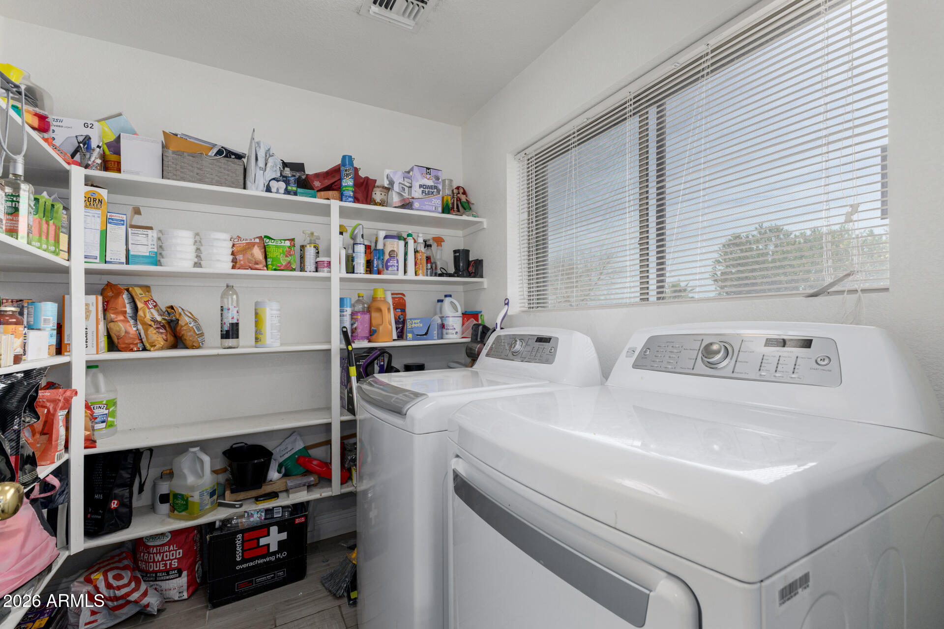 1022 East Pedro Road Phoenix, AZ 85042 - Photo 24 of 29 a utility room with lots of clutter and cabinets