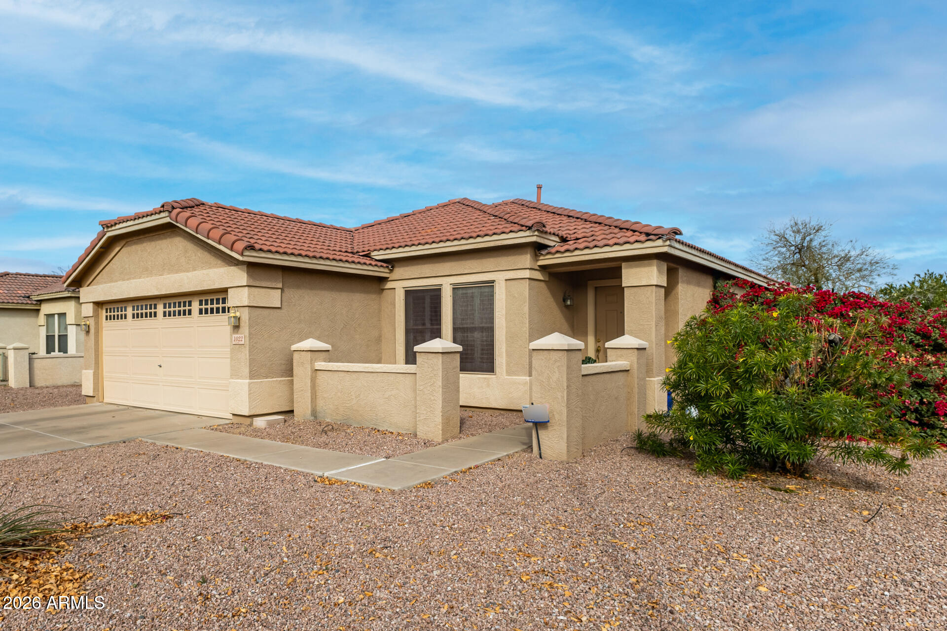 1022 East Pedro Road Phoenix, AZ 85042 - Photo 4 of 29 a front view of a house with a yard and garage