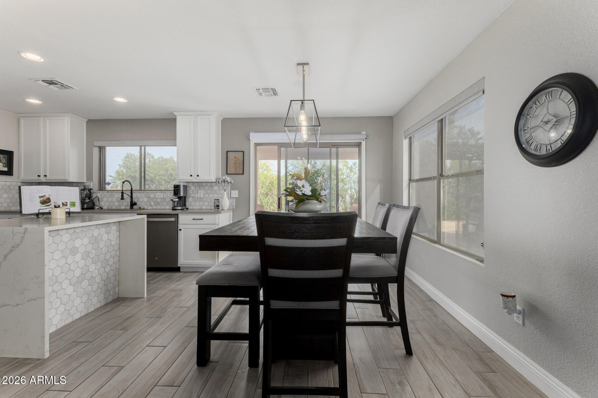 1022 East Pedro Road Phoenix, AZ 85042 - Photo 10 of 29 a view of a dining room with furniture window and wooden floor