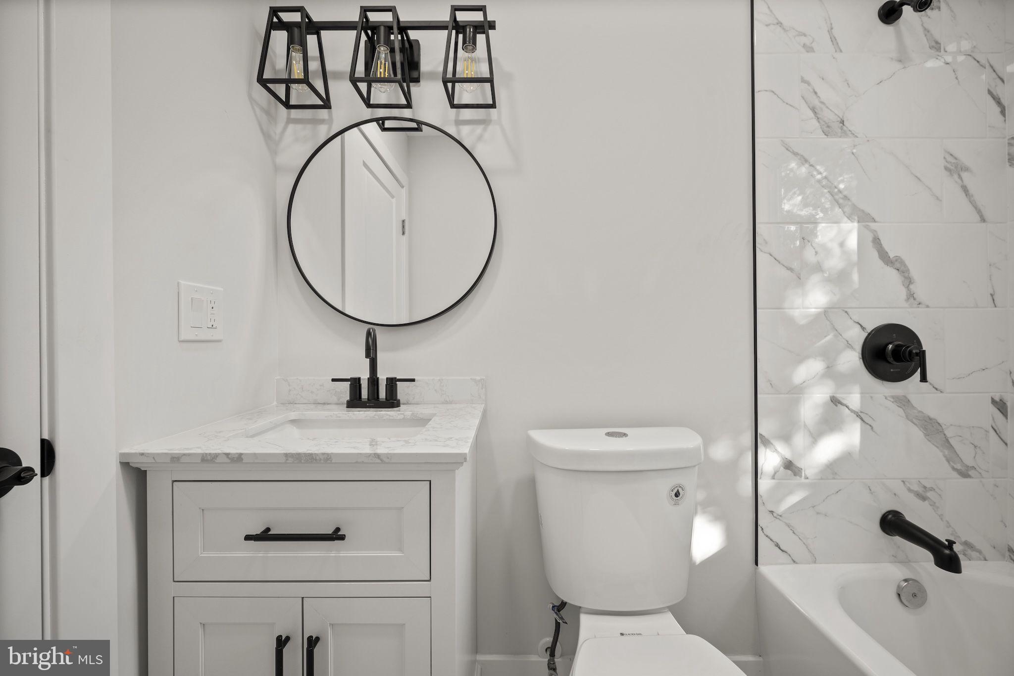821 South Woodlynn Road Baltimore, MD 21221 - Photo 12 of 32 a bathroom with a sink a toilet and a mirror