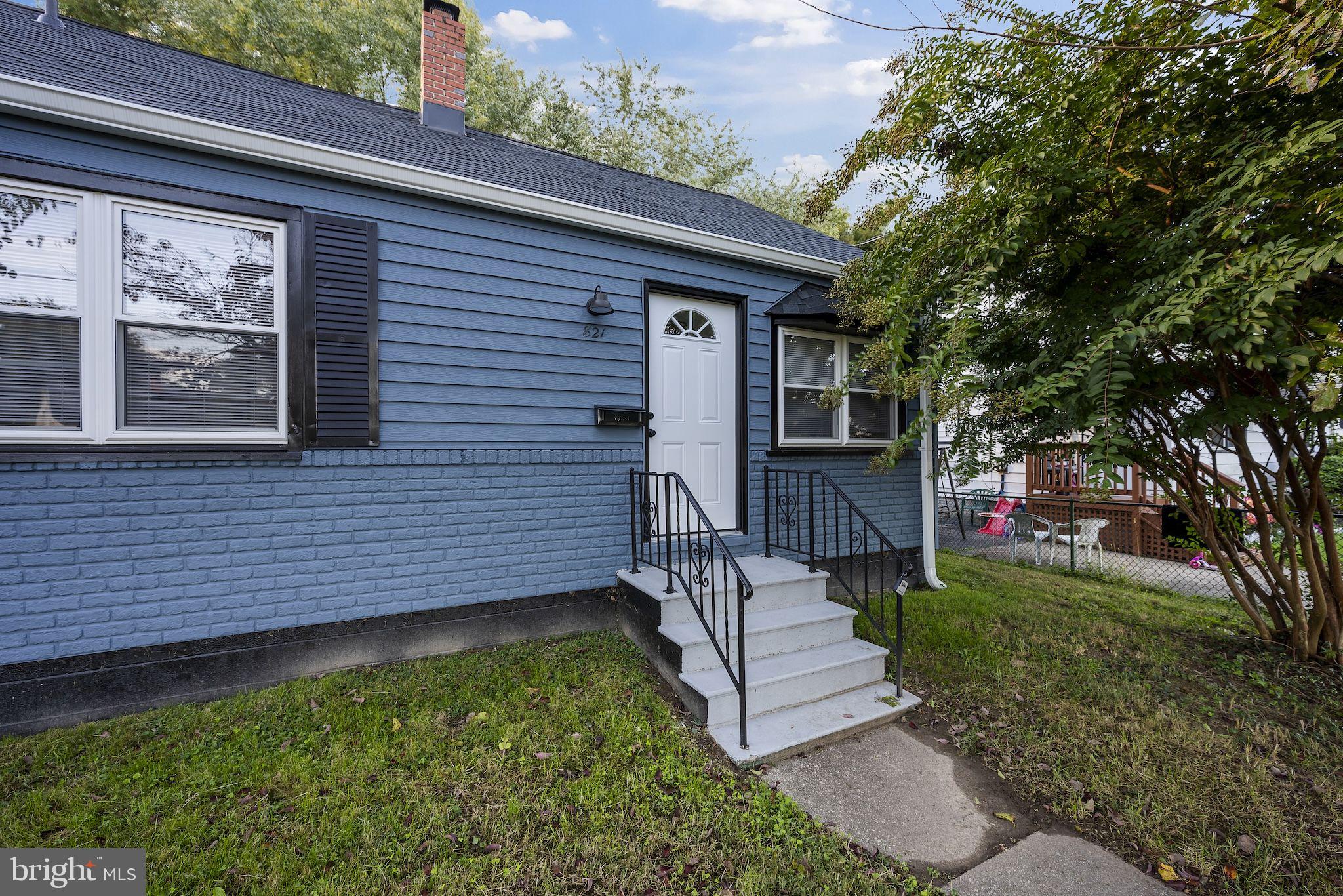 821 South Woodlynn Road Baltimore, MD 21221 - Photo 29 of 32 a view of a house with a small yard plants and large tree
