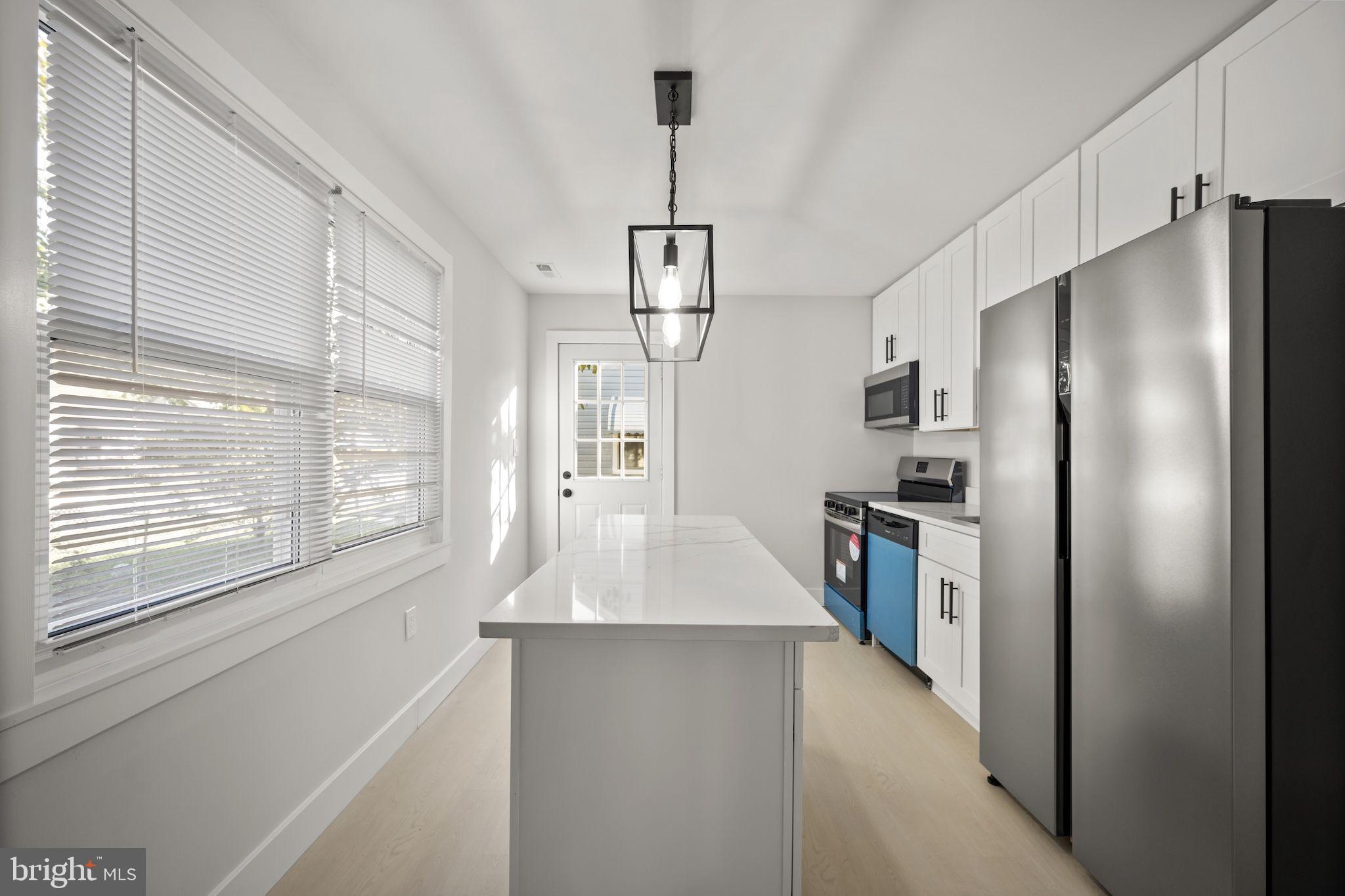 821 South Woodlynn Road Baltimore, MD 21221 - Photo 6 of 32 a kitchen with stainless steel appliances a refrigerator and a window