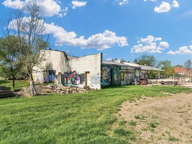 a view of a house with a big yard and large trees
