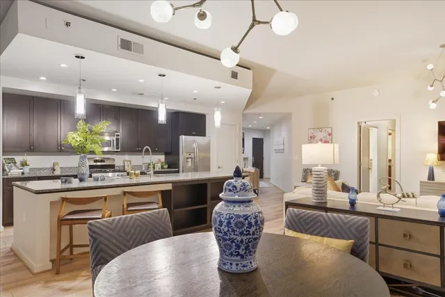 a large kitchen with a table and chairs