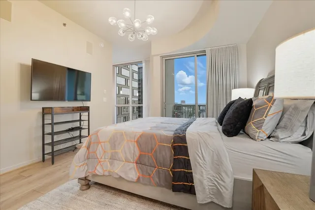 a bedroom with a bed and a flat screen tv