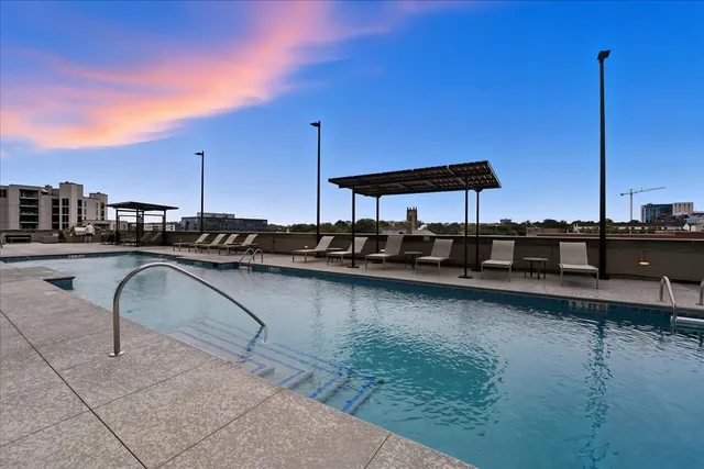 a view of a swimming pool with outdoor seating