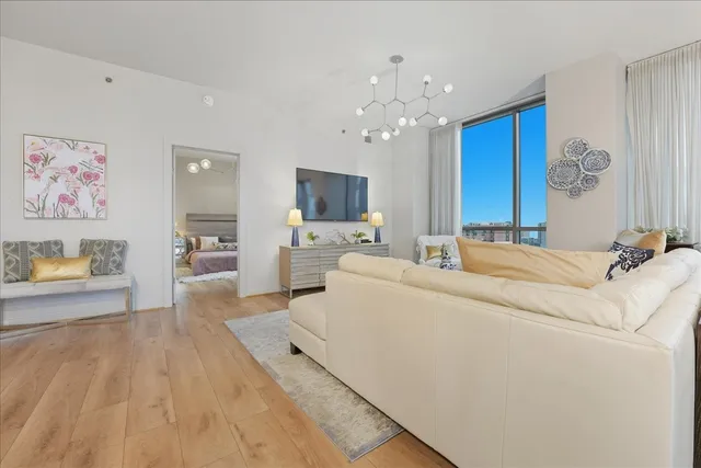 a living room with furniture and a chandelier