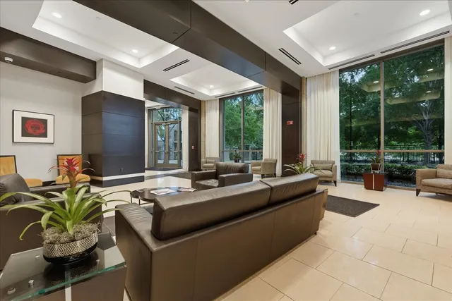 a living room with furniture and large windows