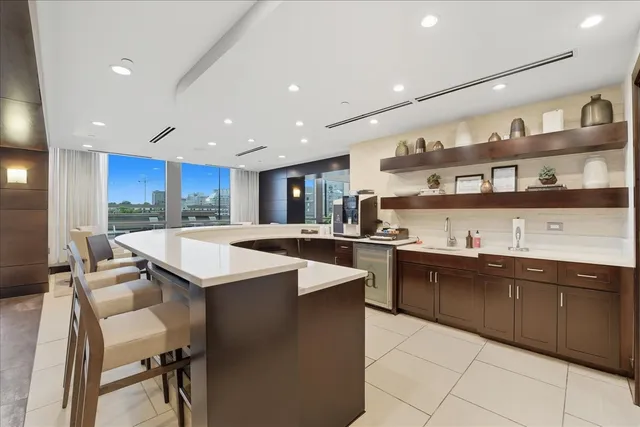 a kitchen with kitchen island granite countertop a sink and counter space