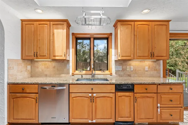 a kitchen with granite countertop cabinets and window