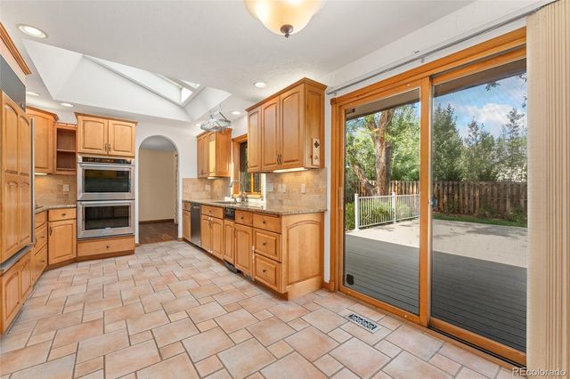 a kitchen with stainless steel appliances a sink and cabinets